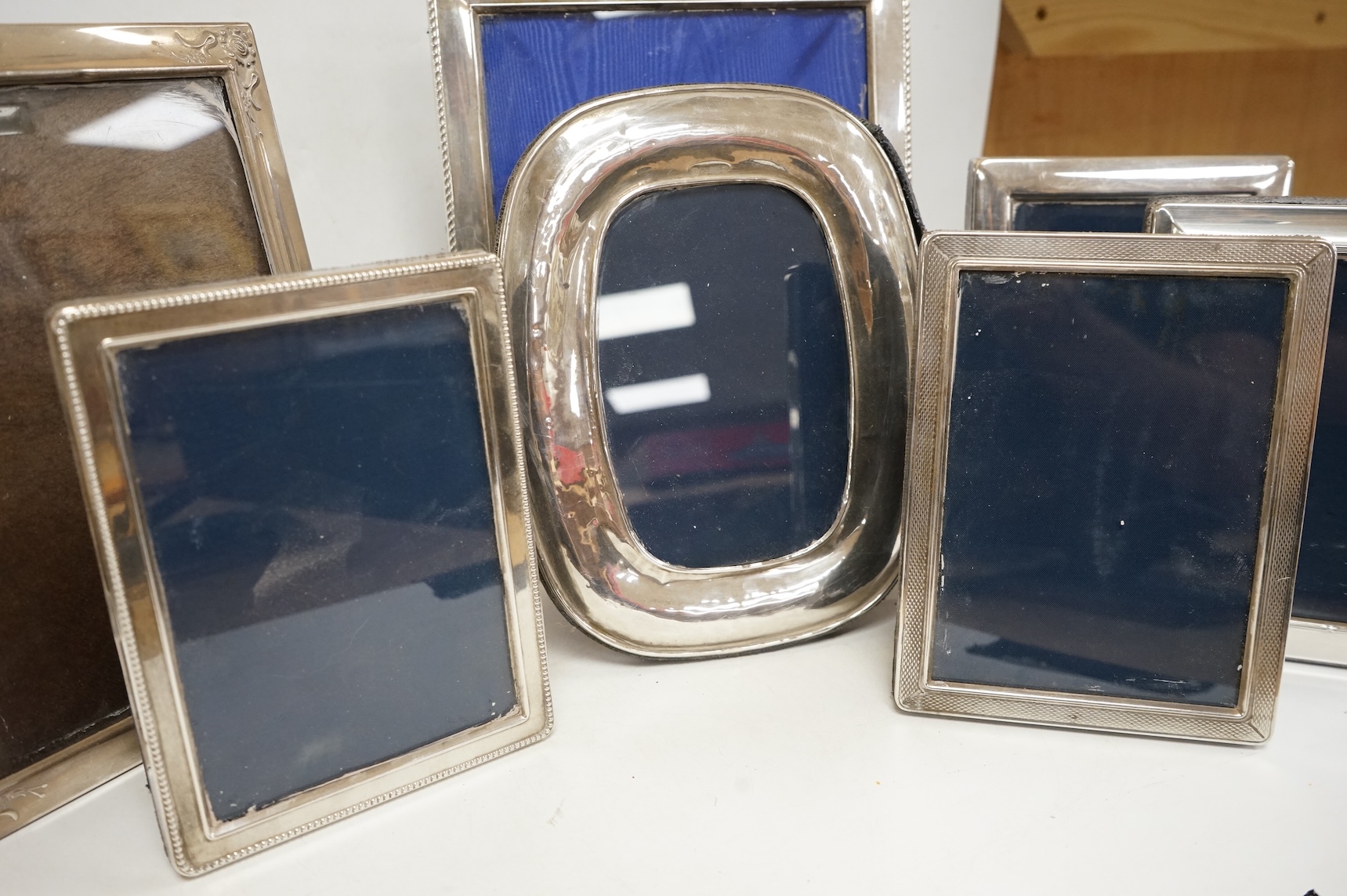 A pair of modern engine turned silver mounted rectangular photograph frames, by Carr's of Sheffield, Sheffield, 1992/3, 14.8cm, together with seven other modern silver mounted photograph frames, largest 23.1cm.